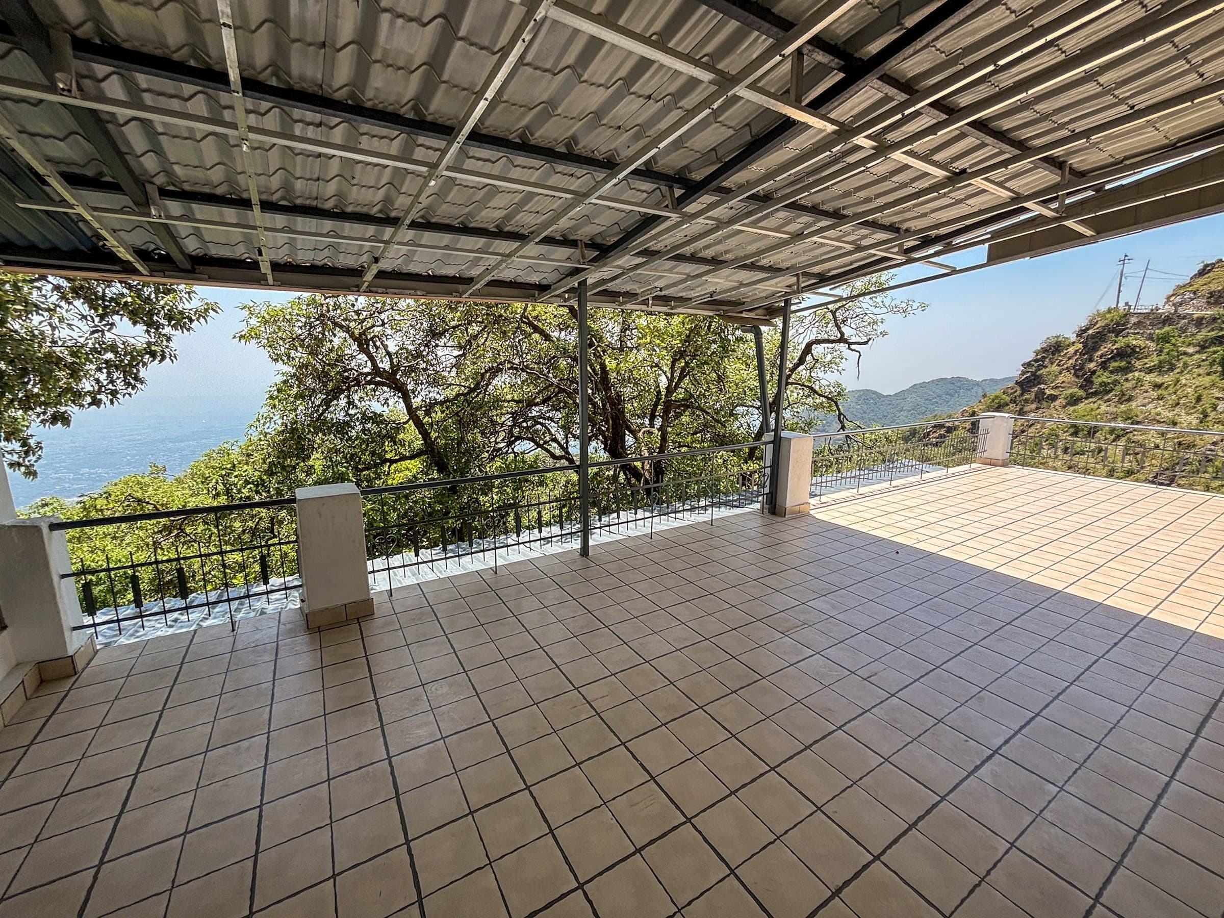 The covered terrace at Shail Shikhar, tiled and open to the valley, shared by rooms 2 and 4